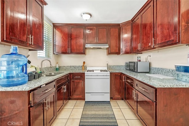 5915 Weedpatch, Bakersfield, CA 93307 - kitchen with gas range gas stove, a sink, under cabinet range hood, stainless steel microwave, and dark brown cabinets
