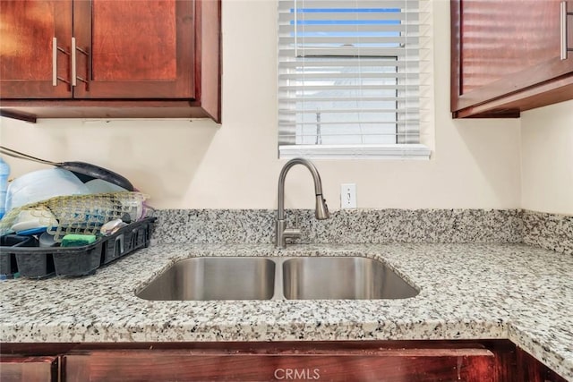 5915 Weedpatch, Bakersfield, CA 93307 - kitchen view of a sink, light stone counters, and reddish brown cabinets
