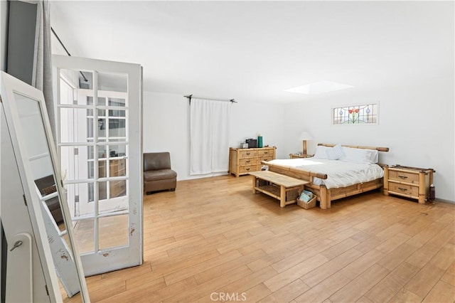 317 Walnut St, Costa Mesa, CA 92627 - bedroom with a skylight and light wood-style floors