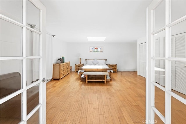317 Walnut St, Costa Mesa, CA 92627 - bedroom with a skylight, french doors, and light wood finished floors