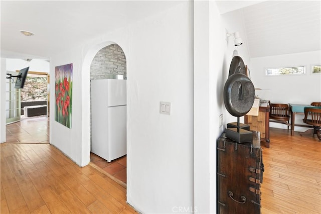 317 Walnut St, Costa Mesa, CA 92627 - corridor with light wood-style flooring and arched walkways