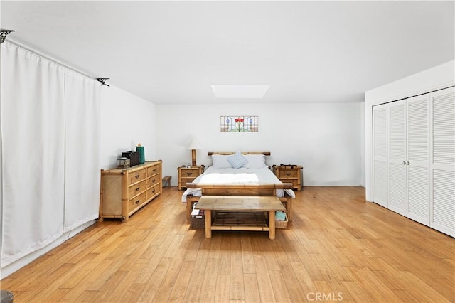 317 Walnut St, Costa Mesa, CA 92627 - bedroom with light wood-style flooring, a skylight, and a closet