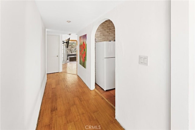 317 Walnut St, Costa Mesa, CA 92627 - hallway featuring light wood-style floors and arched walkways