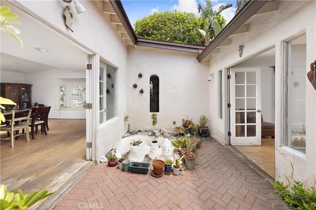 317 Walnut St, Costa Mesa, CA 92627 - property entrance featuring a patio area, stucco siding, french doors, and outdoor dining space