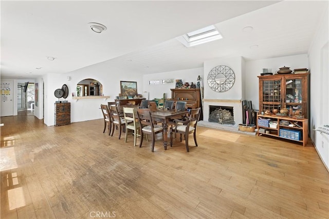 317 Walnut St, Costa Mesa, CA 92627 - dining room featuring light wood-style floors and a fireplace with raised hearth