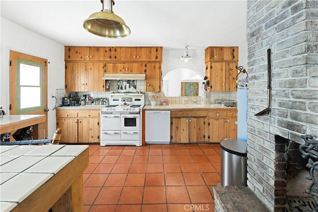 317 Walnut St, Costa Mesa, CA 92627 - kitchen featuring white appliances, under cabinet range hood, tile counters, backsplash, and tile patterned floors