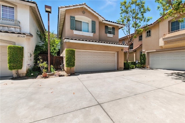 25323 Bayside Pl, Harbor City, CA 90710 - mediterranean / spanish-style home featuring a garage, stucco siding, driveway, and a tile roof