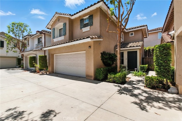 25323 Bayside Pl, Harbor City, CA 90710 - view of front of house featuring a tiled roof, stucco siding, an attached garage, and driveway