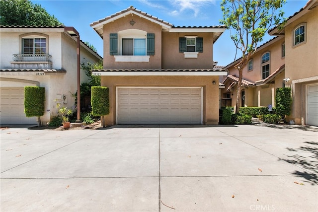 25323 Bayside Pl, Harbor City, CA 90710 - mediterranean / spanish-style house with an attached garage, stucco siding, concrete driveway, and a tile roof