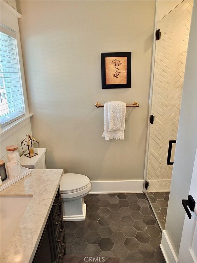 1820 Carfax Ave, Long Beach, CA 90815 - full bathroom with a stall shower, toilet, vanity, and baseboards