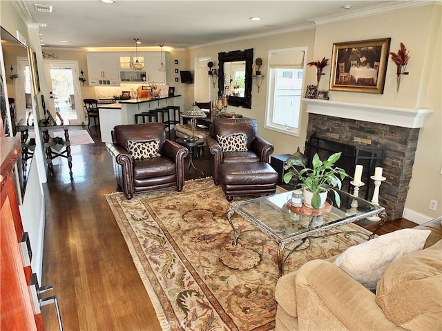 1820 Carfax Ave, Long Beach, CA 90815 - living area with ornamental molding, healthy amount of natural light, dark wood-style floors, recessed lighting, and a stone fireplace