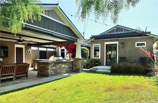 1820 Carfax Ave, Long Beach, CA 90815 - rear view of property featuring an outdoor kitchen, a yard, stucco siding, and board and batten siding