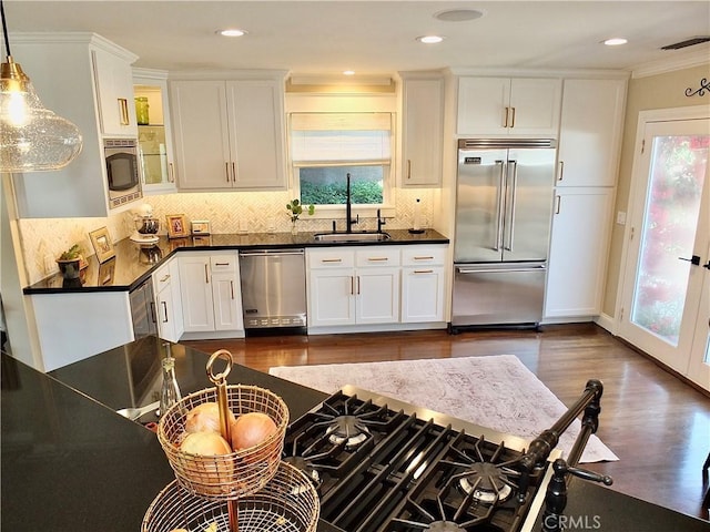 1820 Carfax Ave, Long Beach, CA 90815 - kitchen featuring built in appliances, a sink, dark wood-style floors, dark countertops, and white cabinets
