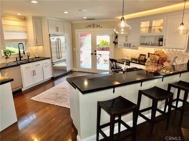 1820 Carfax Ave, Long Beach, CA 90815 - kitchen featuring stainless steel appliances, a sink, french doors, backsplash, and healthy amount of natural light