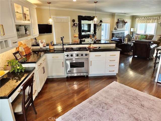 1820 Carfax Ave, Long Beach, CA 90815 - kitchen with premium stove, a peninsula, ornamental molding, dark countertops, and dark wood-style floors