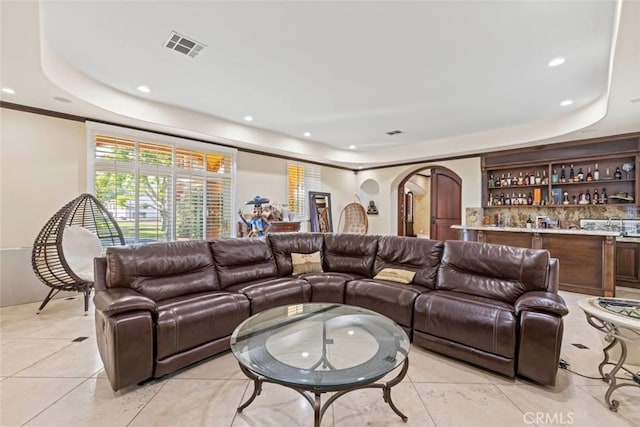 14667 Tyler St, Sylmar, CA 91342 - living area featuring a tray ceiling, arched walkways, bar, light tile patterned flooring, and recessed lighting