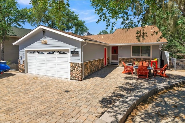 2303 Ridge Rider Rd, Bradley, CA 93426 - ranch-style home featuring stone siding, an attached garage, driveway, and a shingled roof