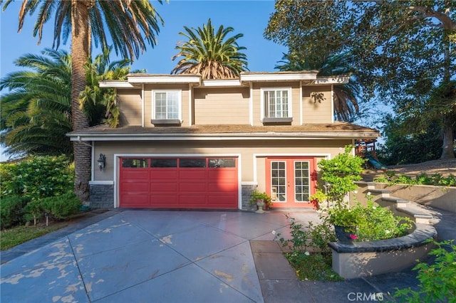 435 S Estate Dr, Orange, CA 92869 - view of front of property with concrete driveway, french doors, a garage, and stone siding