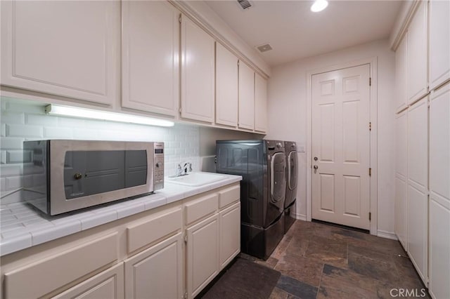435 S Estate Dr, Orange, CA 92869 - laundry room with separate washer and dryer, cabinet space, dark stone finish flooring, baseboards, and recessed lighting