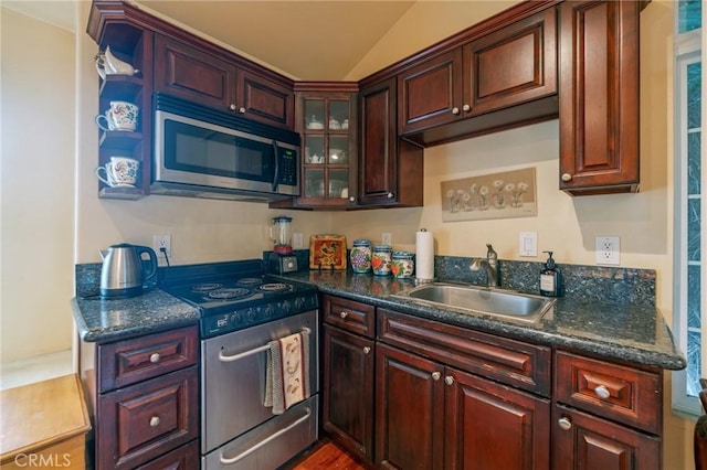 435 S Estate Dr, Orange, CA 92869 - kitchen featuring stainless steel appliances, a sink, glass insert cabinets, wood finished floors, and lofted ceiling