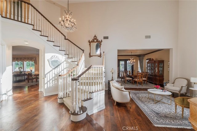 435 S Estate Dr, Orange, CA 92869 - stairs featuring a chandelier, a high ceiling, wood finished floors, arched walkways, and baseboards