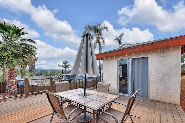 wooden terrace featuring outdoor dining area