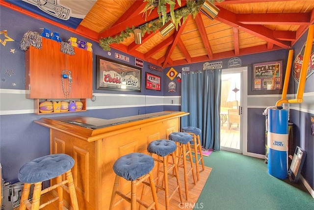 indoor dry bar with wood ceiling, carpet floors, and baseboards
