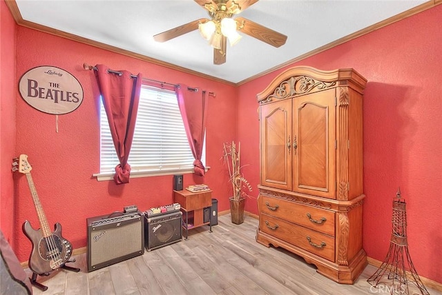 bedroom featuring light wood finished floors, baseboards, ornamental molding, and ceiling fan