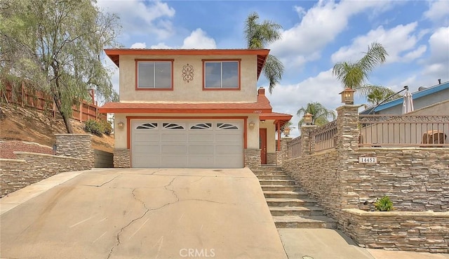 view of front of property with an attached garage, stucco siding, driveway, and stairway
