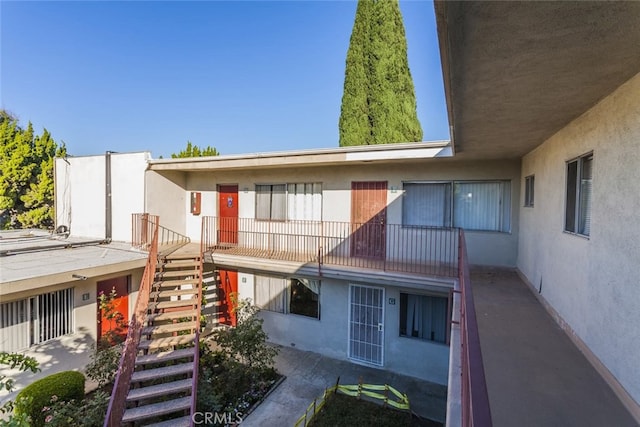 10622 Tibbs Cir, Garden Grove, CA 92840 - rear view of property featuring stairs and stucco siding