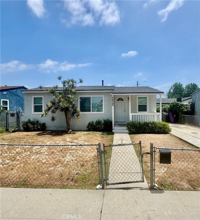 5046 Pacific Ave, Long Beach, CA 90805 - view of front of house with stucco siding, a gate, and a fenced front yard