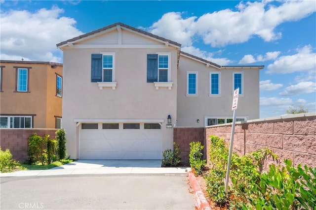 8713 Roving Pl, Chino, CA 91708 - view of front of home with driveway, a garage, and stucco siding