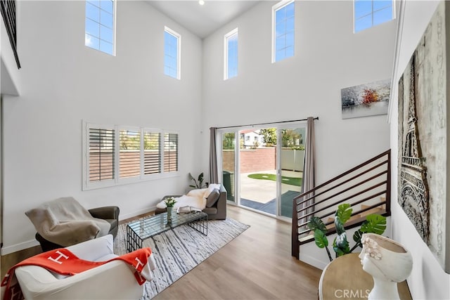 8713 Roving Pl, Chino, CA 91708 - living area with a towering ceiling, wood finished floors, and baseboards