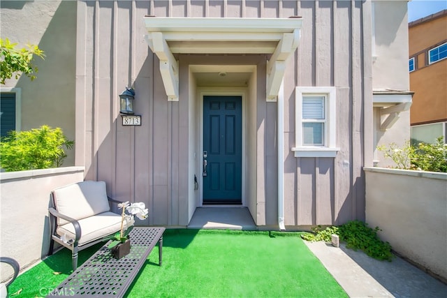 8713 Roving Pl, Chino, CA 91708 - doorway to property with board and batten siding