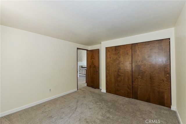 27559 N Bay, Lake Arrowhead, CA 92352 - unfurnished bedroom featuring light carpet, baseboards, and a closet