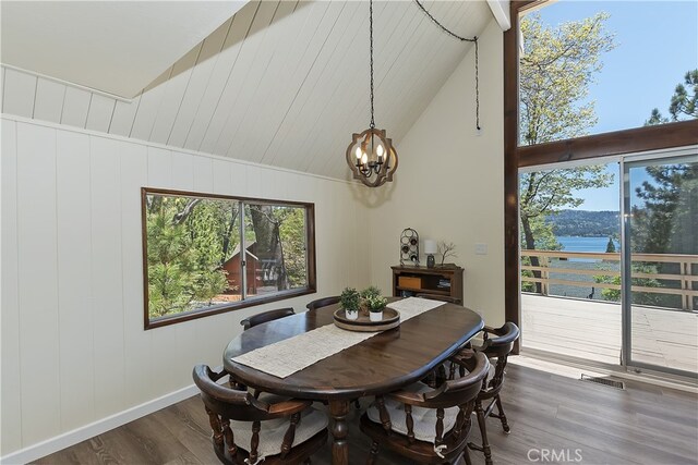 27559 N Bay, Lake Arrowhead, CA 92352 - dining space featuring dark wood-style flooring, a chandelier, high vaulted ceiling, and baseboards