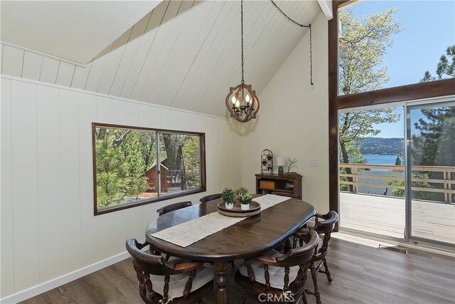 27559 N Bay, Lake Arrowhead, CA 92352 - dining area featuring a chandelier, dark wood-type flooring, high vaulted ceiling, and baseboards