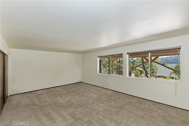 27559 N Bay, Lake Arrowhead, CA 92352 - spare room with light colored carpet, plenty of natural light, and baseboards