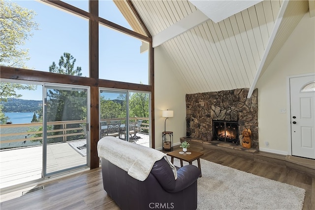 27559 N Bay, Lake Arrowhead, CA 92352 - living room featuring high vaulted ceiling, wood finished floors, plenty of natural light, a fireplace, and baseboards