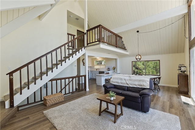27559 N Bay, Lake Arrowhead, CA 92352 - living room with high vaulted ceiling, beamed ceiling, wood finished floors, stairway, and baseboards
