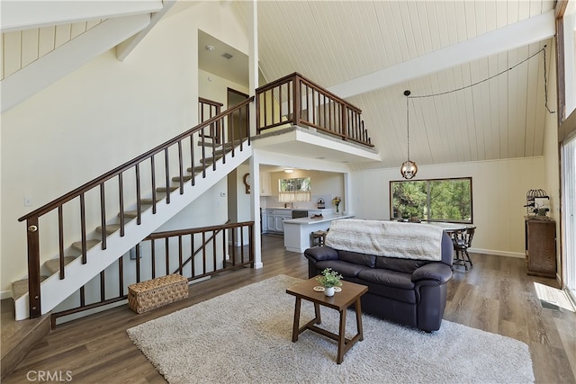 27559 N Bay, Lake Arrowhead, CA 92352 - living area featuring high vaulted ceiling, beamed ceiling, wood finished floors, stairs, and baseboards