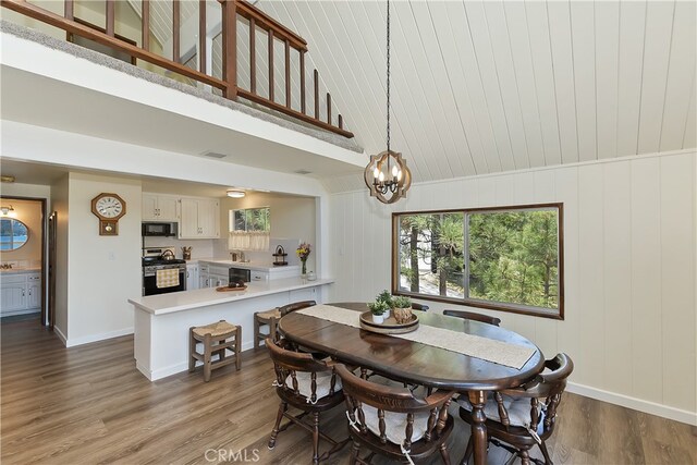 27559 N Bay, Lake Arrowhead, CA 92352 - dining space with wood finished floors, baseboards, a chandelier, and lofted ceiling