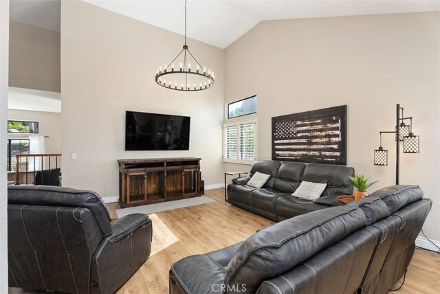 25311 Darlington, Mission Viejo, CA 92692 - living room with a chandelier, high vaulted ceiling, light wood-style floors, plenty of natural light, and baseboards