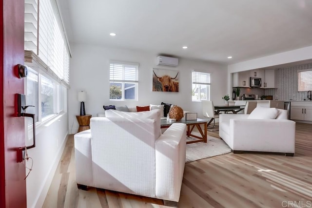 5028 Monroe Ave, San Diego, CA 92115 - living area featuring a wall unit AC, light wood-style flooring, and recessed lighting