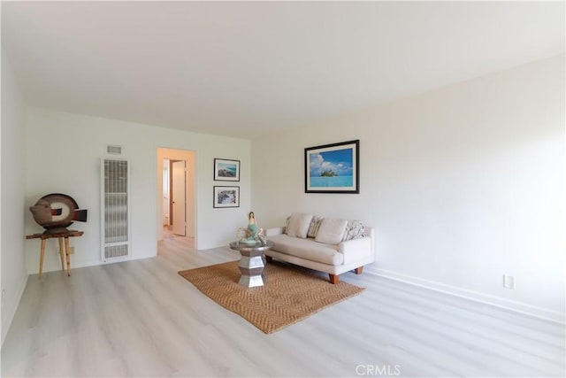 801 E 1st St Unit 17, Long Beach, CA 90802 - living room with a heating unit, light wood-style floors, and baseboards
