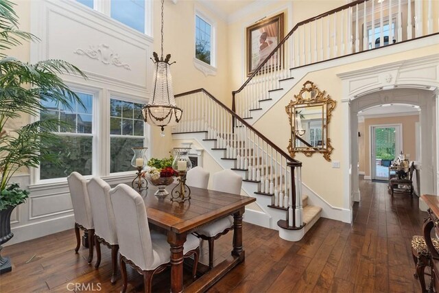3 Blue Spruce Dr, Ladera Ranch, CA 92694 - dining room with a towering ceiling, hardwood / wood-style flooring, stairs, arched walkways, and crown molding