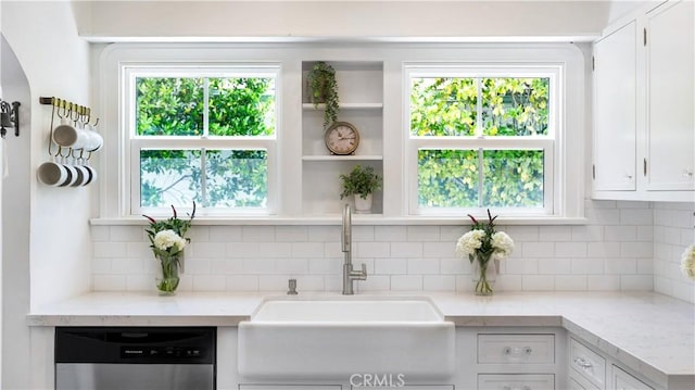 2336 N Riverside Dr, Santa Ana, CA 92706 - kitchen with stainless steel dishwasher, a sink, white cabinets, and decorative backsplash