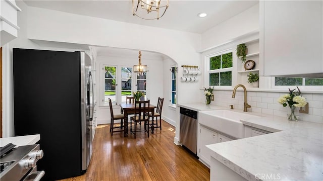 2336 N Riverside Dr, Santa Ana, CA 92706 - kitchen with appliances with stainless steel finishes, a chandelier, a sink, wood finished floors, and recessed lighting