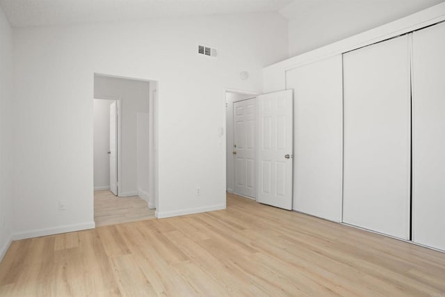 4888 Northerly St, Oceanside, CA 92056 - unfurnished bedroom featuring wood finished floors, baseboards, a closet, and high vaulted ceiling