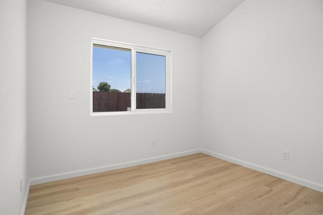 4888 Northerly St, Oceanside, CA 92056 - unfurnished room with light wood finished floors, baseboards, and a textured ceiling